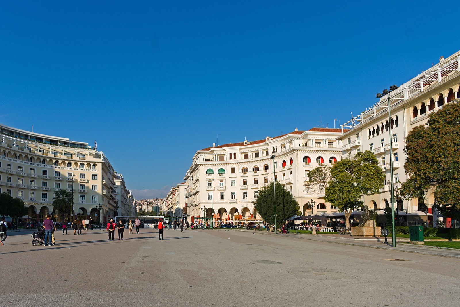 Aristotelous Square's arcaded buildings curving toward the sea