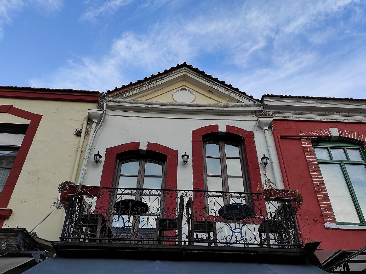 Restored colourful merchant houses with balconies in Ladadika