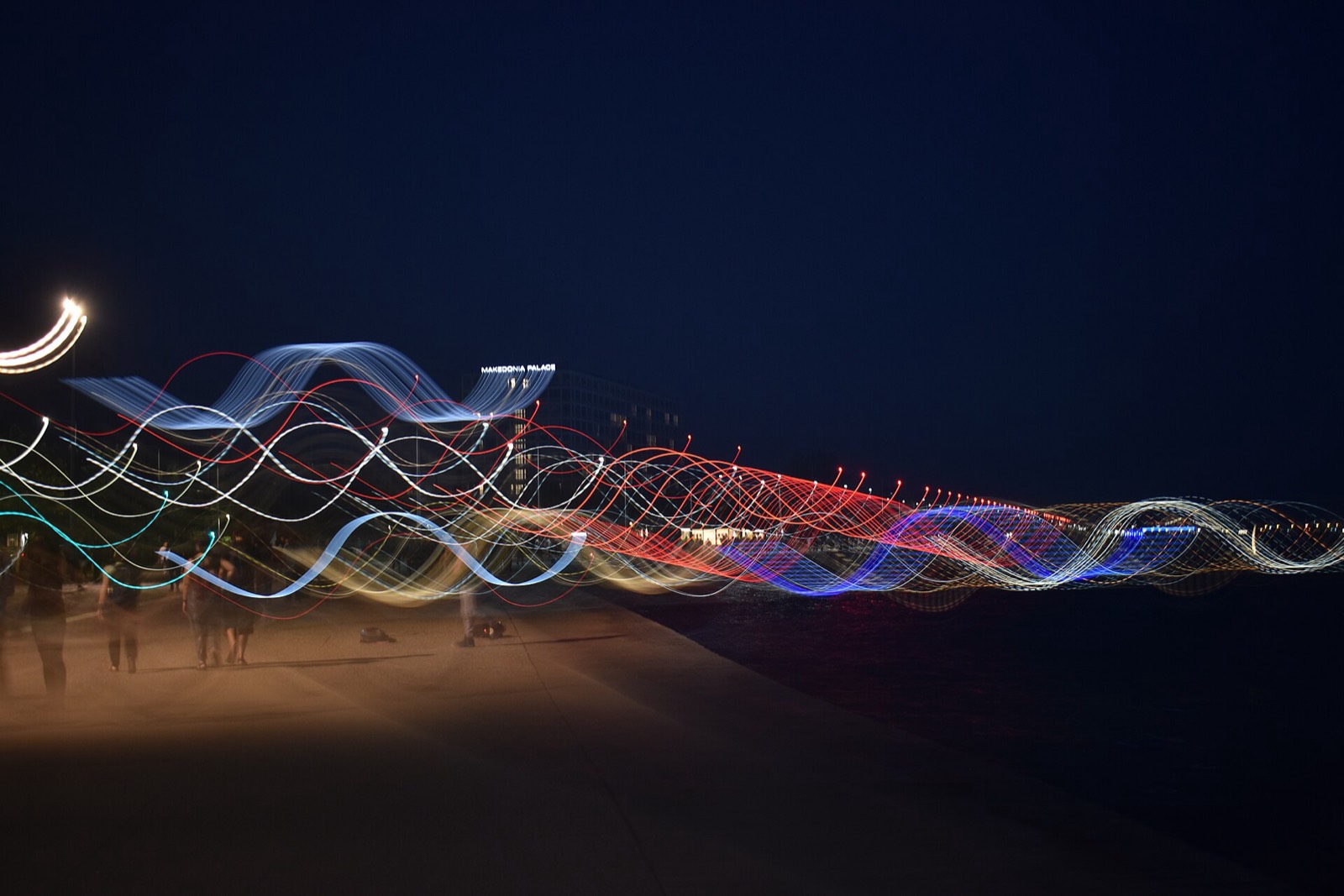 Long-exposure light trails along the Thessaloniki seafront at night